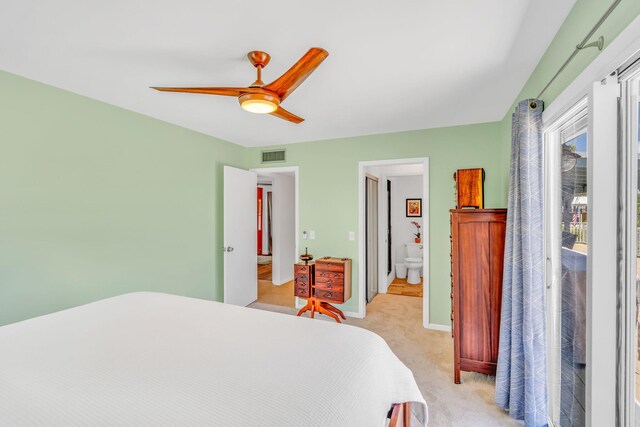 17126 Wahoo Ln, Sugarloaf, FL 33042 - bedroom with light colored carpet, ceiling fan, ensuite bath, and baseboards