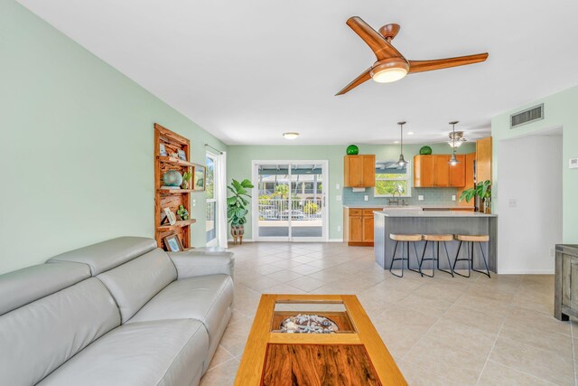 17126 Wahoo Ln, Sugarloaf, FL 33042 - living area with light tile patterned floors and a ceiling fan