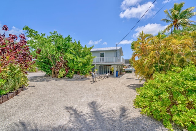 17126 Wahoo Ln, Sugarloaf, FL 33042 - back of house with a balcony and metal roof