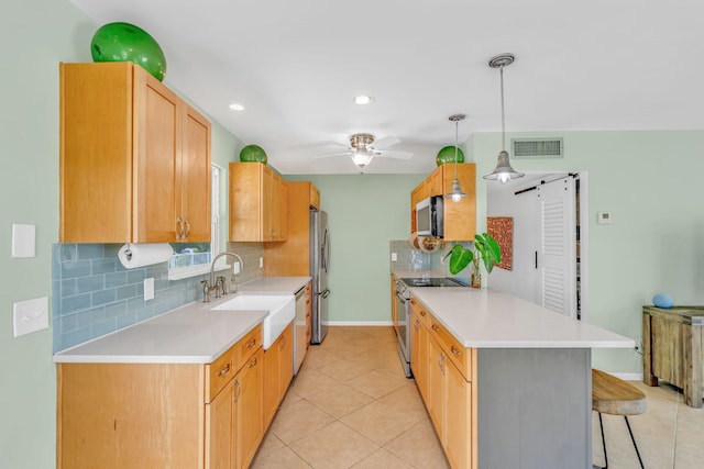17126 Wahoo Ln, Sugarloaf, FL 33042 - kitchen featuring appliances with stainless steel finishes, a peninsula, a sink, a breakfast bar area, and a ceiling fan