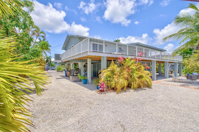 17126 Wahoo Ln, Sugarloaf, FL 33042 - view of front facade with a patio area and a wooden deck