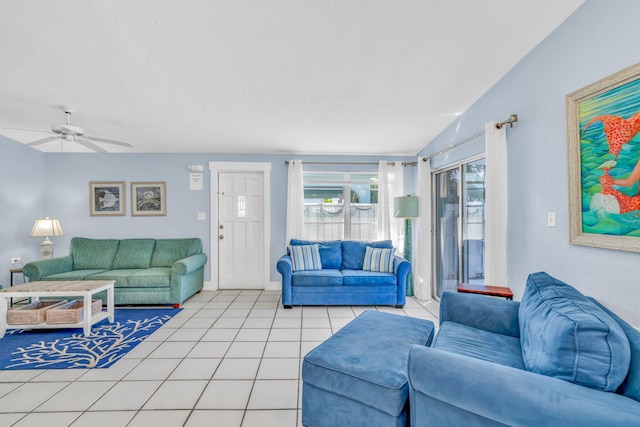 living room featuring light tile patterned floors, baseboards, and ceiling fan