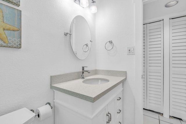 half bathroom with vanity and toilet