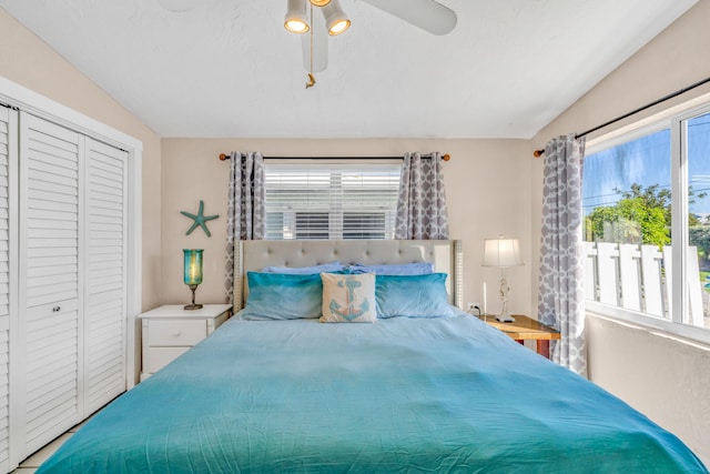 bedroom with lofted ceiling, a closet, and ceiling fan