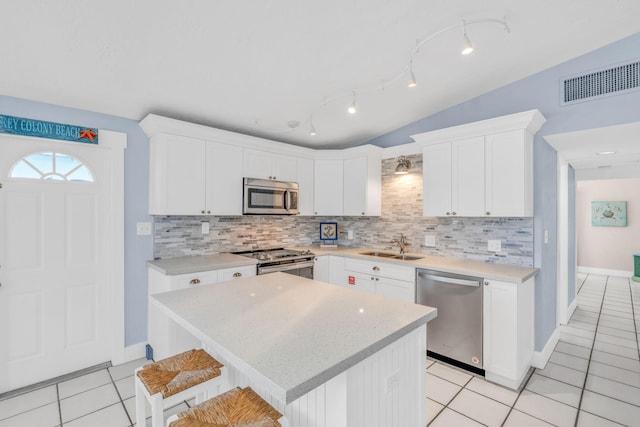 kitchen with visible vents, appliances with stainless steel finishes, light countertops, light tile patterned floors, and decorative backsplash