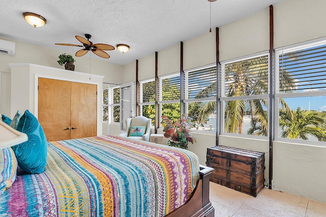 bedroom featuring a textured ceiling and a wall unit AC