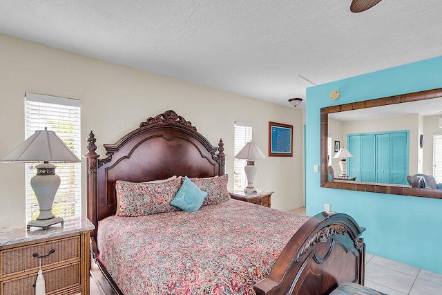 bedroom with tile patterned flooring and a textured ceiling