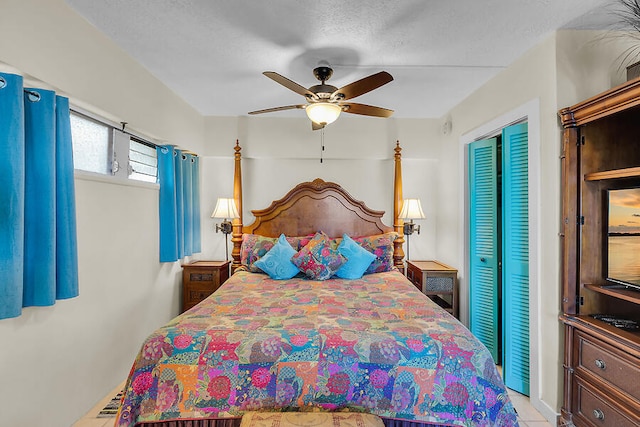 bedroom featuring a ceiling fan and a textured ceiling