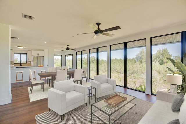 living area with wood finished floors and visible vents