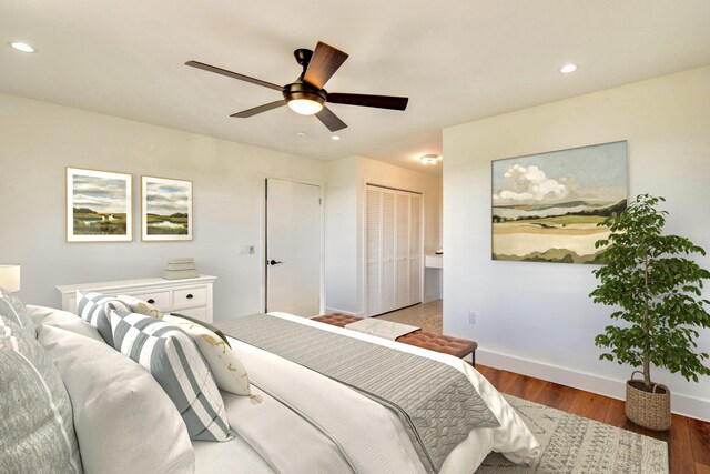 bedroom with recessed lighting, a closet, baseboards, and wood finished floors