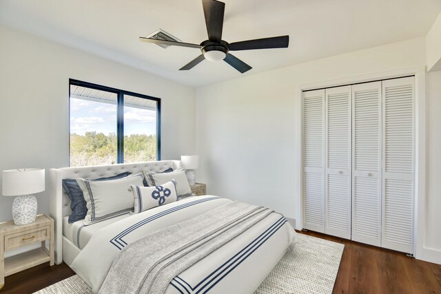 bedroom featuring a closet, dark wood finished floors, and a ceiling fan