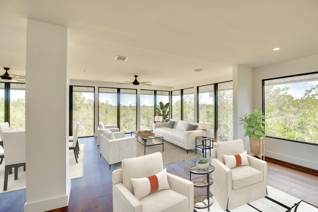 living area featuring recessed lighting, visible vents, baseboards, and wood finished floors