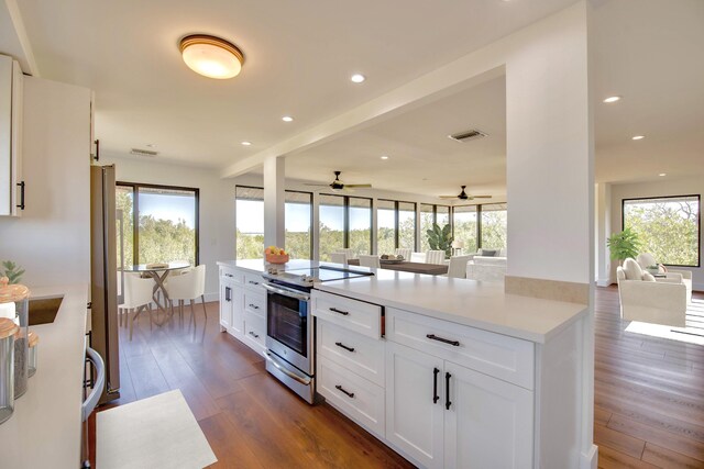 kitchen featuring plenty of natural light, stainless steel appliances, dark wood-type flooring, and open floor plan