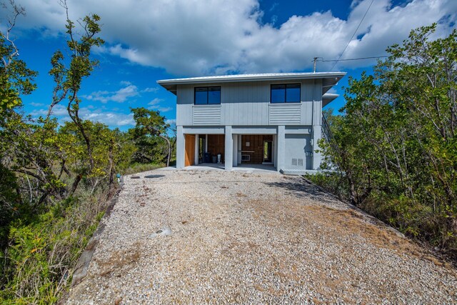 back of house with a carport and driveway