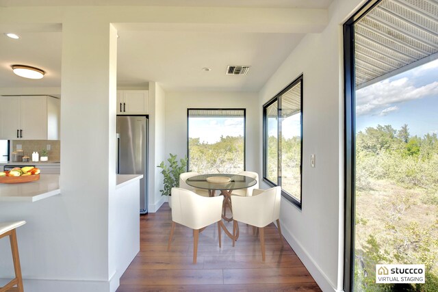 dining space with baseboards, visible vents, dark wood finished floors, and recessed lighting