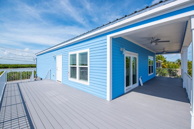 wooden deck featuring a water view and ceiling fan