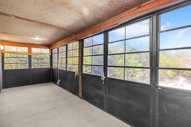 unfurnished sunroom with wood ceiling and a healthy amount of sunlight
