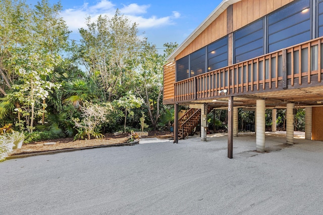 view of patio / terrace featuring a wooden deck and stairs