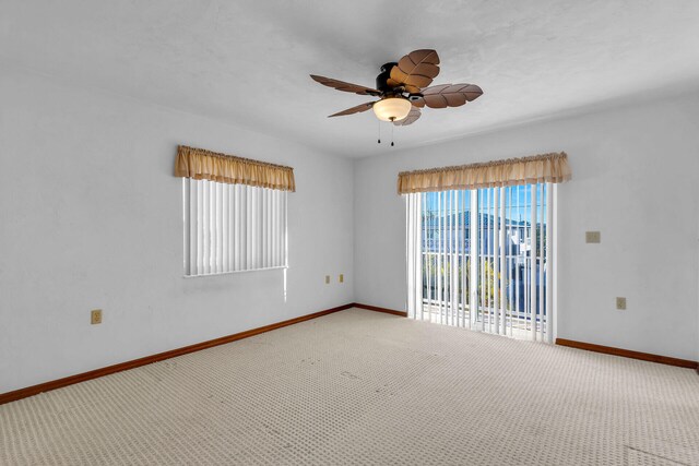 empty room with baseboards, carpet, and a ceiling fan