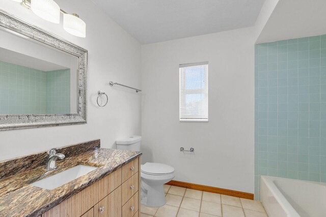 full bathroom with tile patterned flooring, toilet, vanity, and baseboards