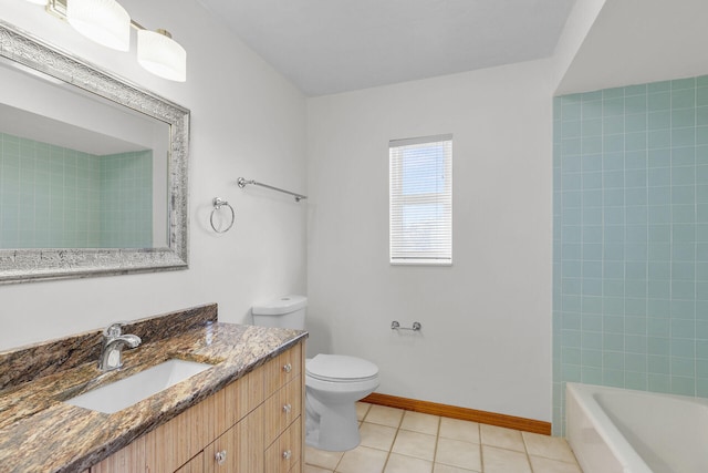 bathroom with tile patterned flooring, toilet, vanity, and baseboards