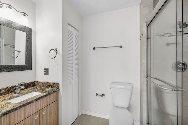 full bath featuring a closet, toilet, a stall shower, and vanity