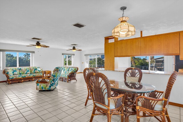 dining room with light tile patterned floors, visible vents, and baseboards