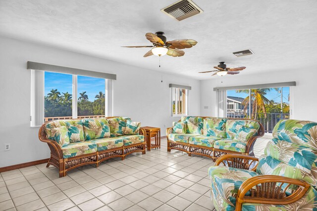 living room featuring visible vents, a healthy amount of sunlight, and light tile patterned flooring