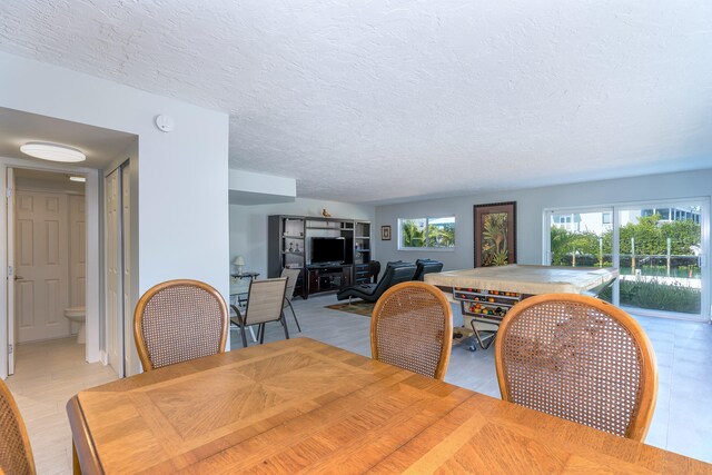 dining room featuring a textured ceiling