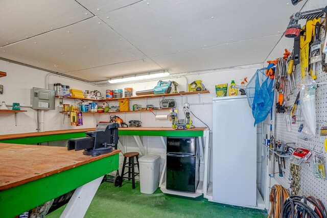 recreation room featuring concrete floors and a workshop area