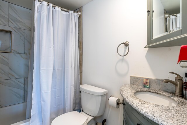 full bath with toilet, shower / bath combo, and vanity