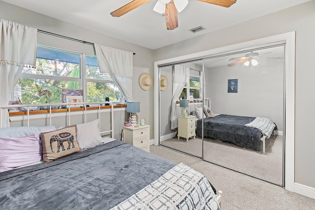 bedroom with ceiling fan, multiple windows, a closet, and visible vents