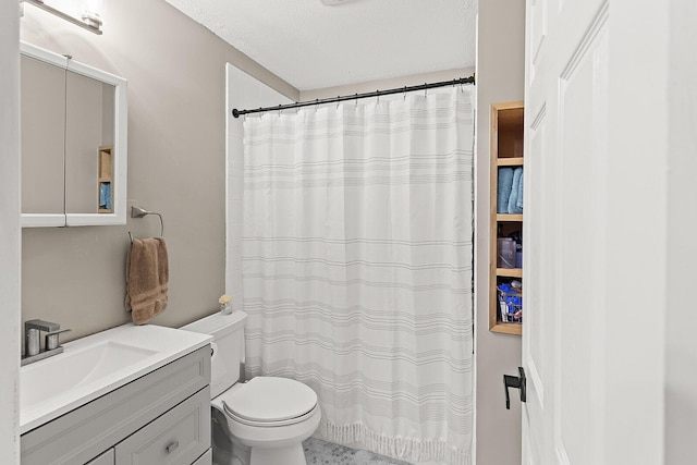 full bath with toilet, a textured ceiling, and vanity