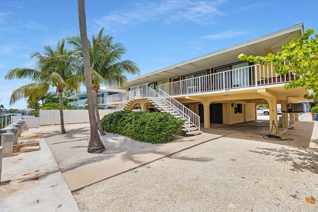 501 9th St, Key Colony, FL 33051 - view of property featuring a carport and stairway