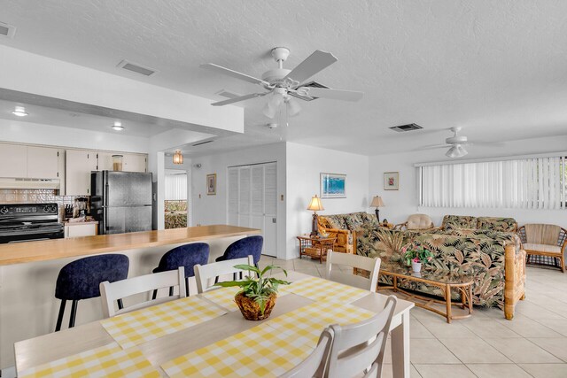 501 9th St, Key Colony, FL 33051 - dining space with ceiling fan, light tile patterned floors, and a textured ceiling