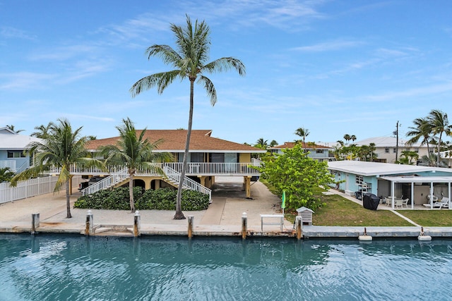 501 9th St, Key Colony, FL 33051 - dock area featuring stairs, a patio area, and a residential view