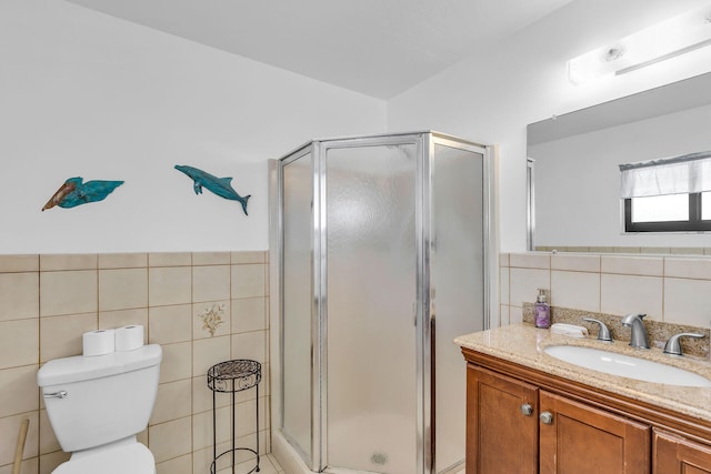 501 9th St, Key Colony, FL 33051 - bathroom with tile walls, vanity, a shower stall, toilet, and wainscoting