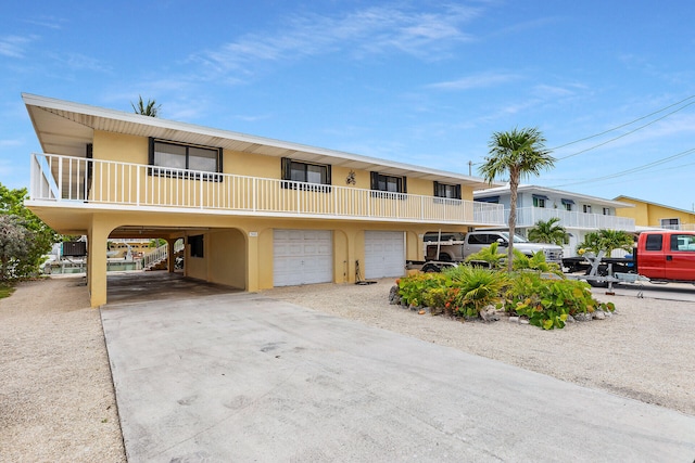501 9th St, Key Colony, FL 33051 - view of front of house with a carport, concrete driveway, and stucco siding