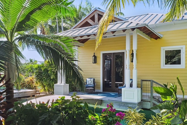 doorway to property with a standing seam roof, metal roof, and french doors