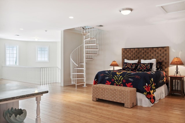 bedroom with attic access, recessed lighting, and light wood finished floors