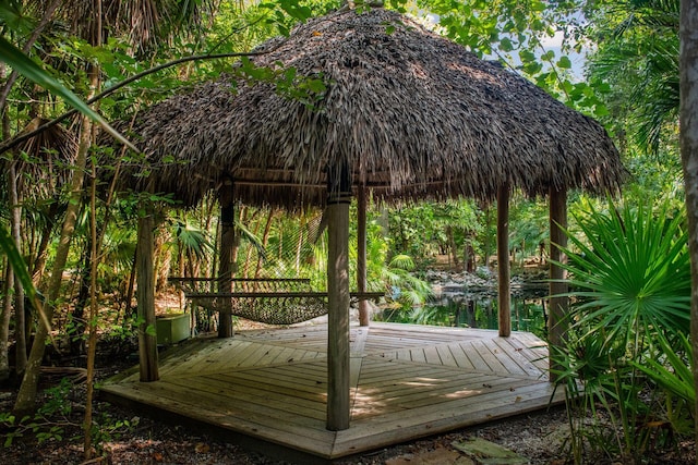 deck featuring a gazebo and a water view