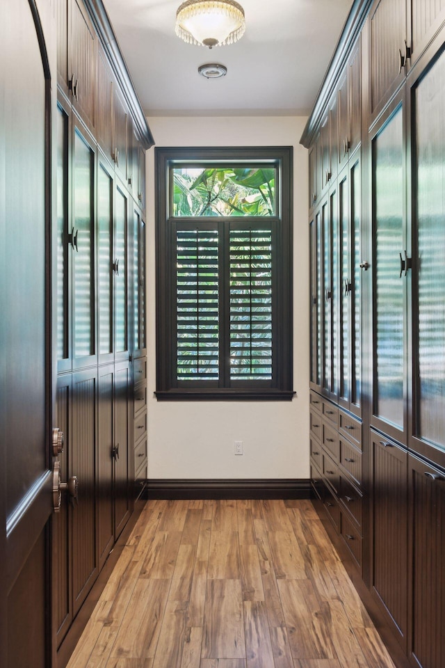 interior space with baseboards and light wood-style floors