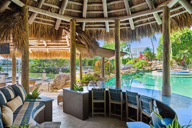 view of patio with an outdoor pool and a gazebo