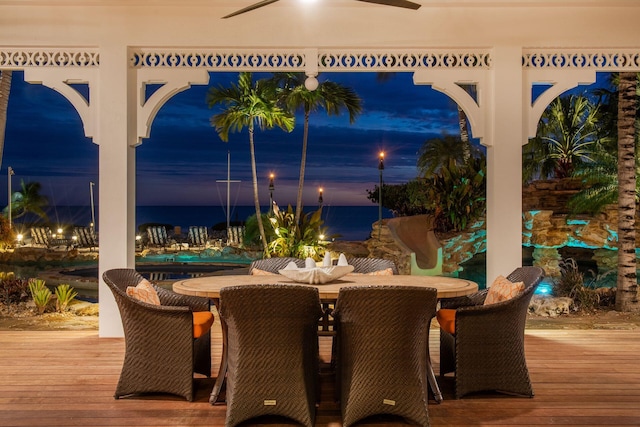 view of patio featuring outdoor dining space, ceiling fan, and a wooden deck