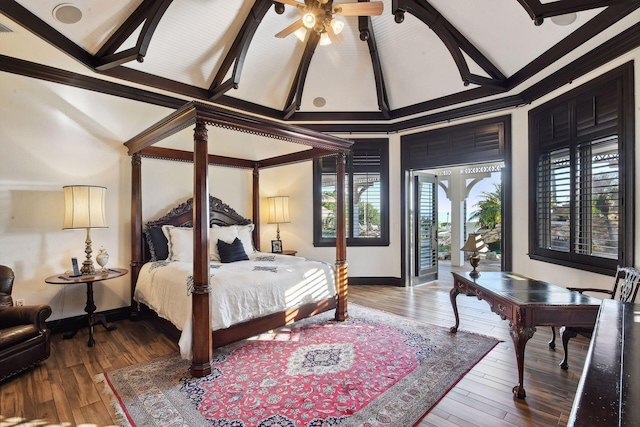 bedroom with access to exterior, visible vents, wood finished floors, beamed ceiling, and baseboards