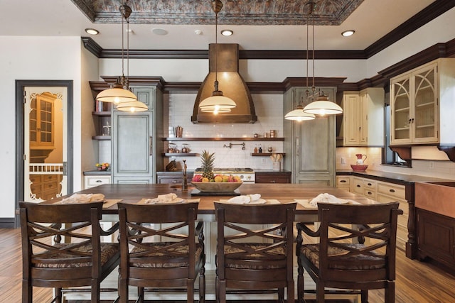 kitchen with hanging light fixtures, dark countertops, open shelves, and glass insert cabinets