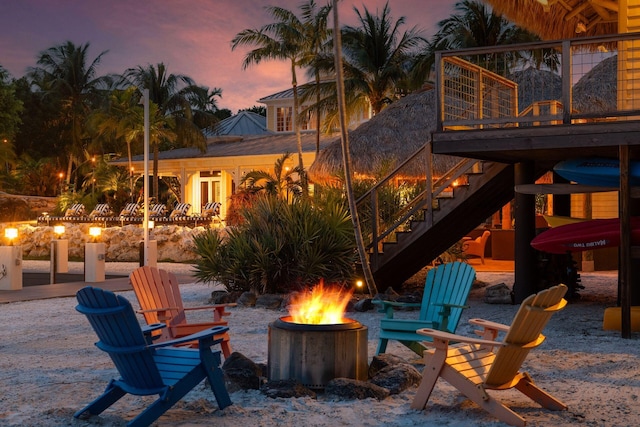 patio terrace at dusk with an outdoor fire pit and stairs