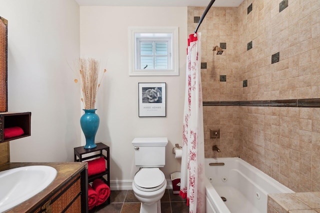 bathroom featuring a combined bath / shower with jetted tub, toilet, vanity, baseboards, and tile patterned floors