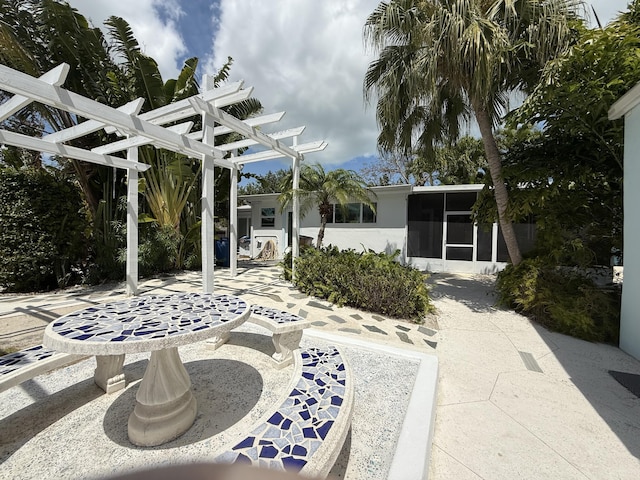 view of patio / terrace featuring a sunroom and a pergola