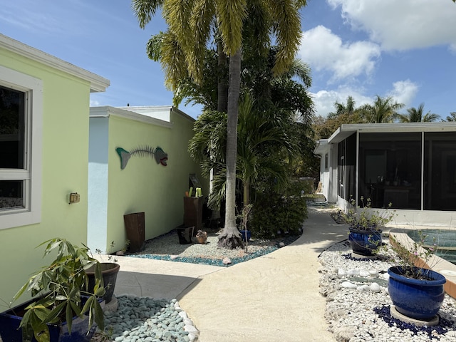 view of yard featuring a sunroom and a patio